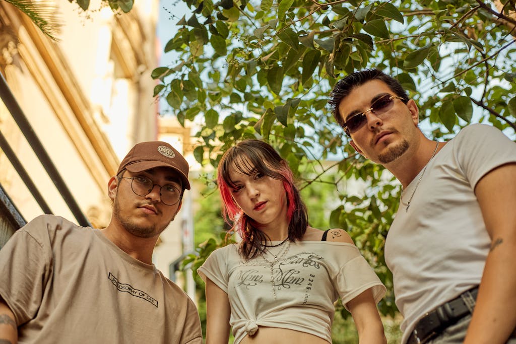 Group of three friends in casual summer attire posing outdoors in Istanbul.